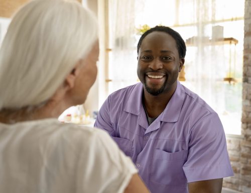 male-social-worker-taking-care-old-woman