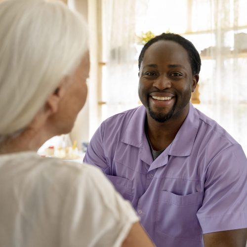 male-social-worker-taking-care-old-woman