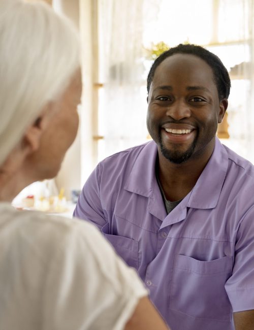 male-social-worker-taking-care-old-woman